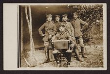 Five uniformed soldiers posing with accordion