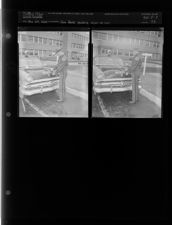 Patrolman Jim Davis putting sign on car (2 Negatives (November 29, 1954) [Sleeve 73, Folder c, Box 5]
