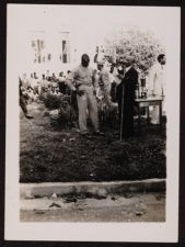 Man in Uniform Stands with a Man in a Suit