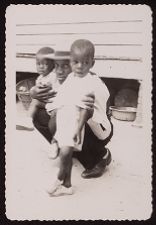 Man Posing with Two Children