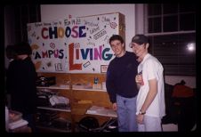 Students with "Choose Campus Living" sign