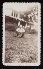 Young man in front of house