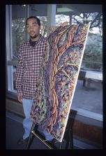 Student standing next to painting