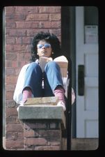 Student sitting on brick wall