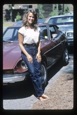 Student leaning on the side of a car