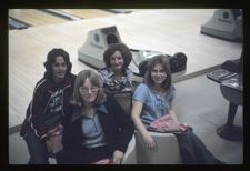 Students sitting by the bowling lanes