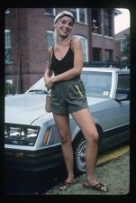 Student standing in front of a car