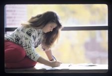 Student writing on a paper
