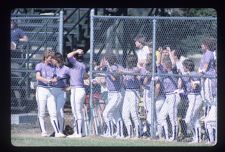 Softball team gathered in their dugout