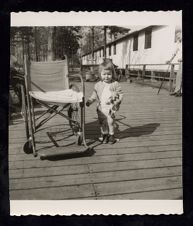 Child with Polio Next to Wheelchair