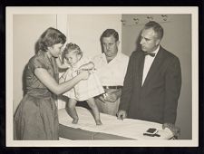 Mother Helps a Child with Polio Stand Up