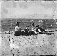 Two couples sitting on the beach