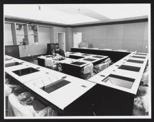 Workers assembling desks inside a classroom in Joyner Library