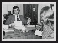 Photograph of Director of Alumni Affairs Don Leggett and a woman working