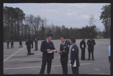 Photographs of Air Force ROTC cadets in dress uniforms preparing for an event