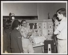 Photograph of Air Force ROTC Cadets and officer standing in front of equipment