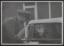 Photograph of Air force ROTC cadet talking to a woman and child in car