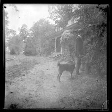 Man with a dog in front of Bayside Plantation house, Pasquotank County, North Carolina