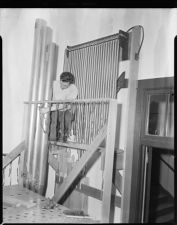 Man working on organ pipes.